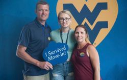 Claire (middle) with her parents on move in day.