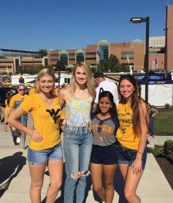 Claire (second from left) with WVU friends at a football game.